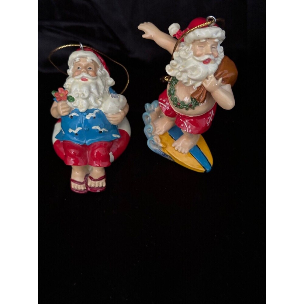 Vintage pair of Tropical Santas, 2.5” santa on float, 3.5” Santa on a skim board